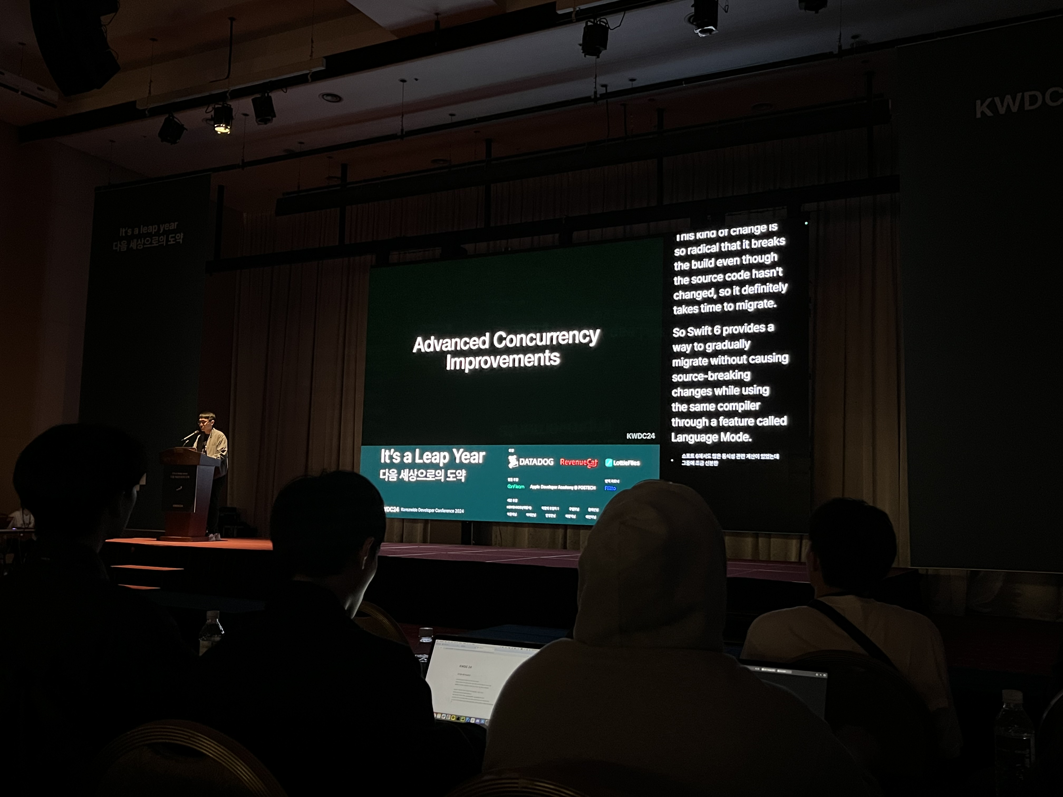 View of the stage during a talk about Swift 6, showing the screen with live translation next to the slides