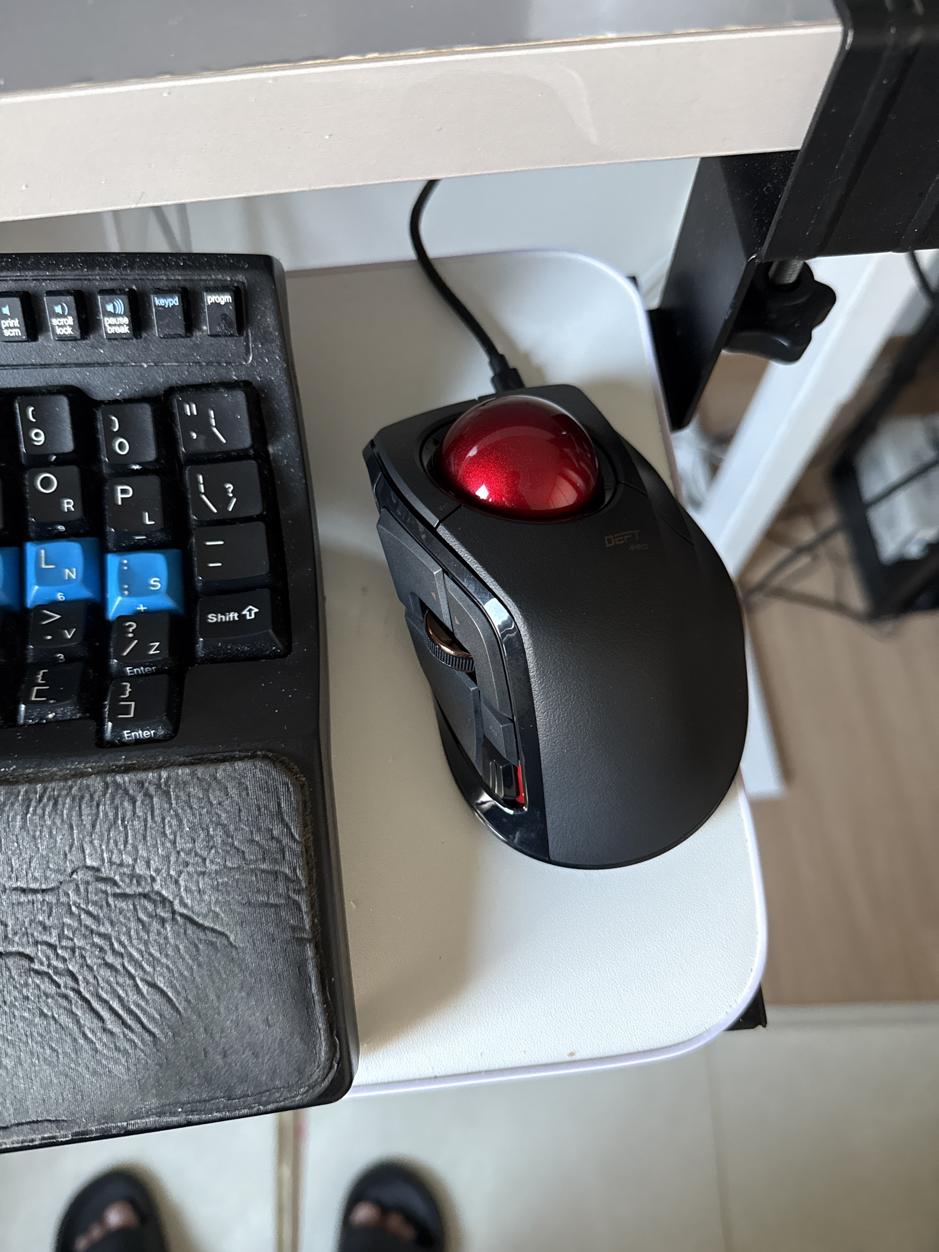 An Elecom Deft Pro trackball, which barely fits on the keyboard tray